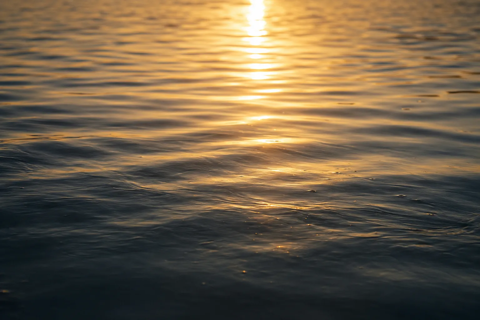 Golden sunlight reflecting on calm water symbolizes slowing down, releasing the high-achiever mindset, and discovering lasting fulfillment within.